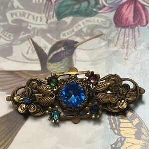 Vintage Floral Brooch w/Blue Center Rhinestone set in ornate gold metal - 1 5/8”